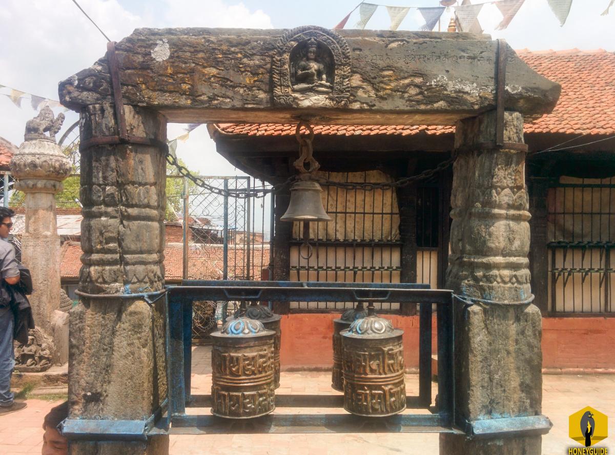 Prayer wheels and Hindu God in the same place at Chilancho Vihar in Kirtipur, Nepal