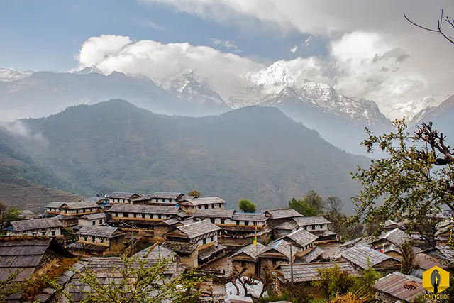 Stone-roofed houses of Ghandruk village with Annapurna South mountain behind