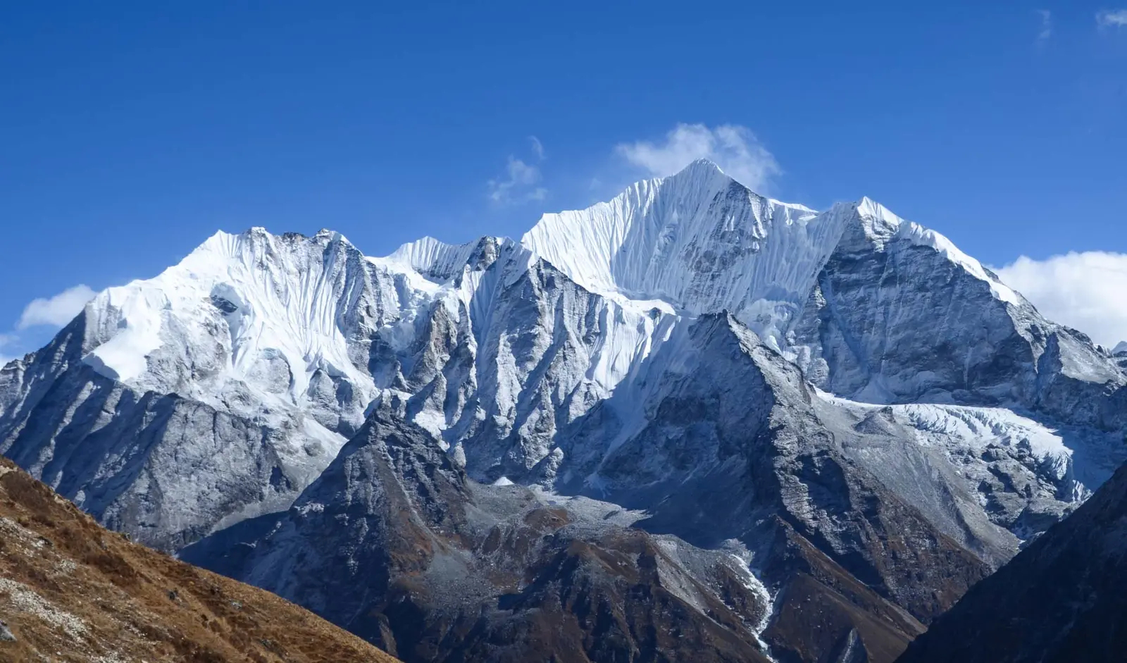 Snow-covered mountains under a clear blue sky in the Langtang Valley