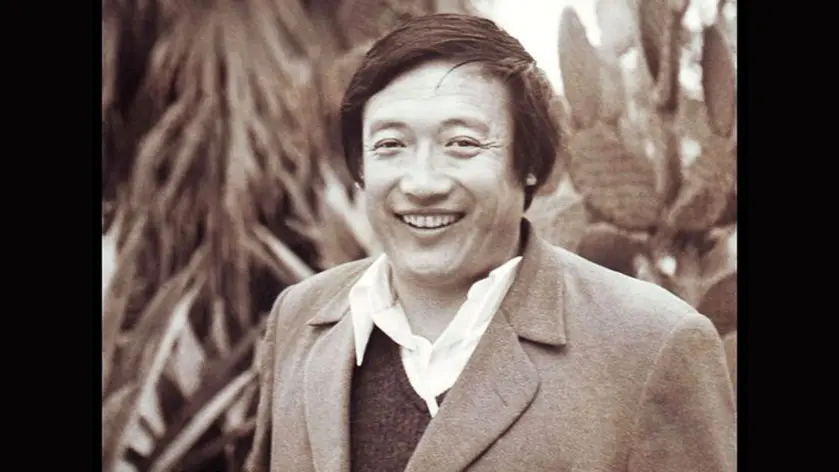 Sepia portrait of a smiling man in a jacket and open-collared shirt
