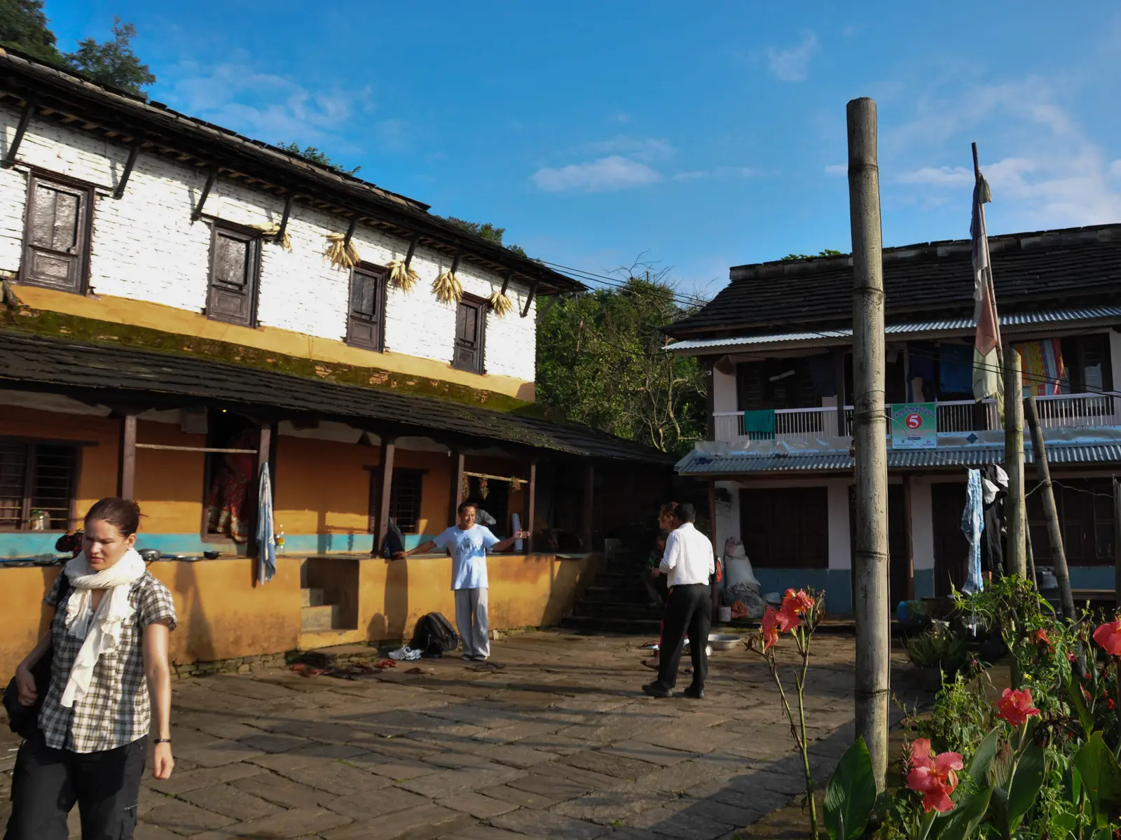 Courtyard of traditional homestay houses with visitors, Lwang