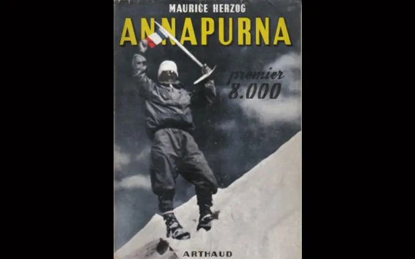 Book cover of Annapurna by Maurice Herzog showing a climber holding a French flag