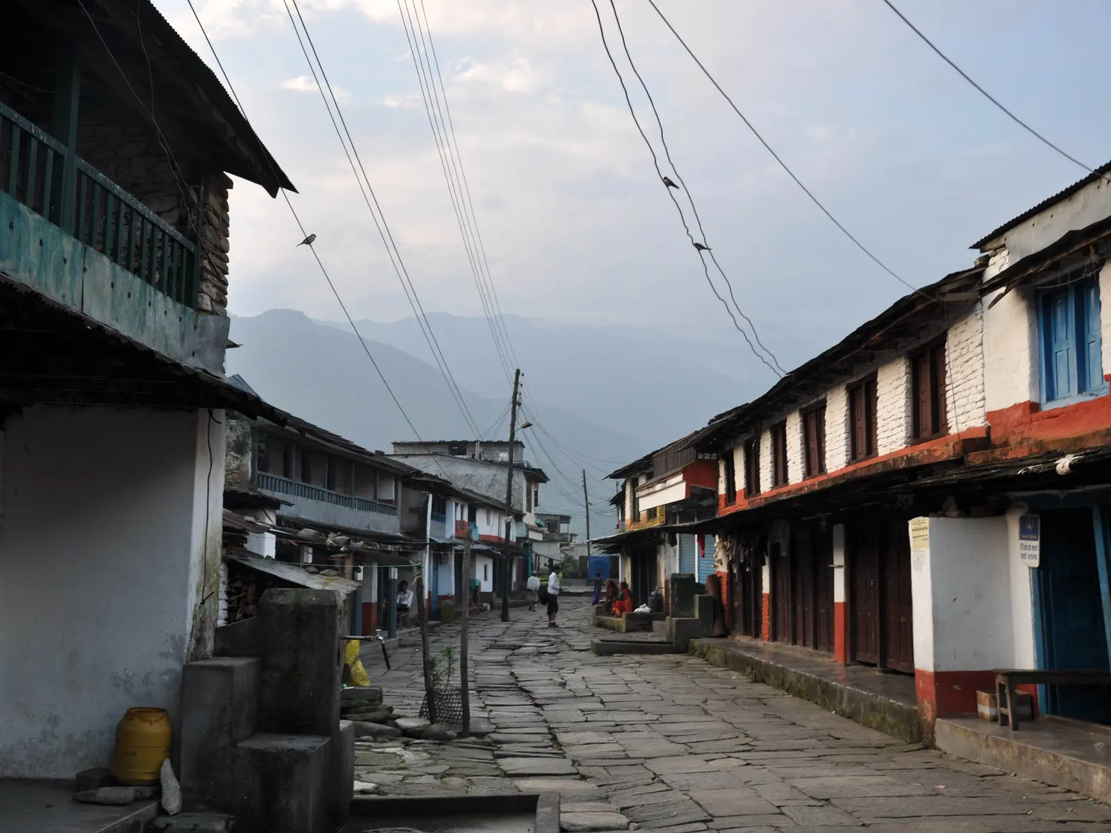 Flagstone street between old two-storey houses in a hill village